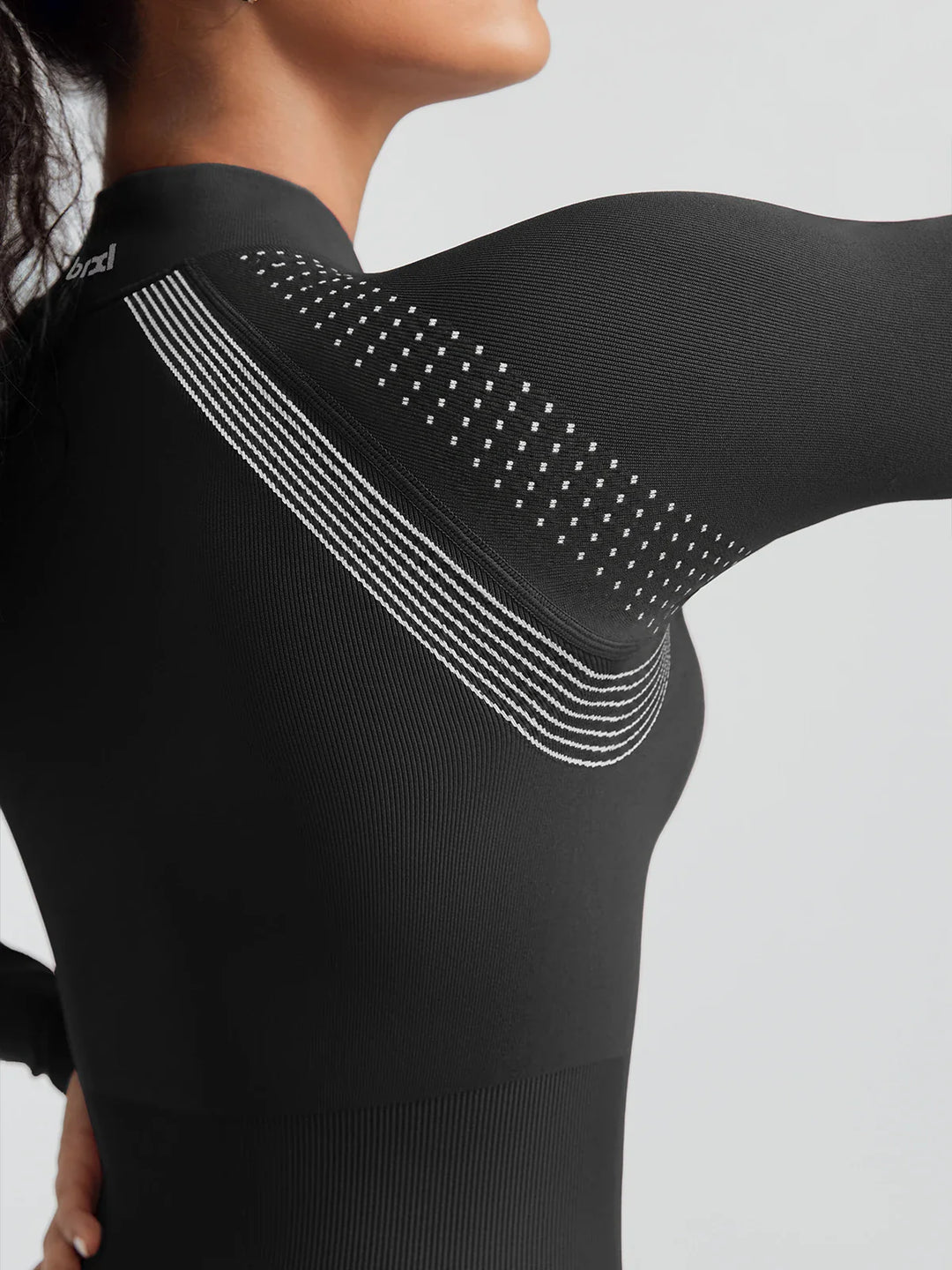 A model wearing a BRXL® BrxlGrit™ Long Sleeve Sculpting Contrast Workout Zip Up Jumpsuit