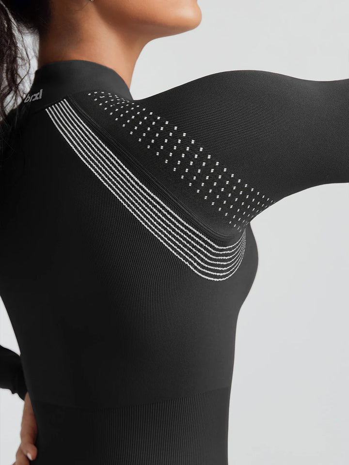 A model wearing a BRXL® BrxlGrit™ Long Sleeve Sculpting Contrast Workout Zip Up Jumpsuit
