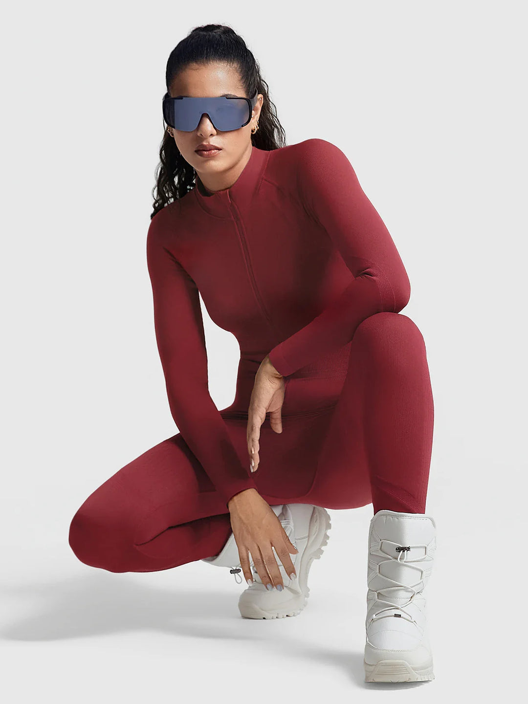 A model wearing a BRXL® BrxlGrit™ Long Sleeve Sculpting Contrast Workout Zip Up Jumpsuit