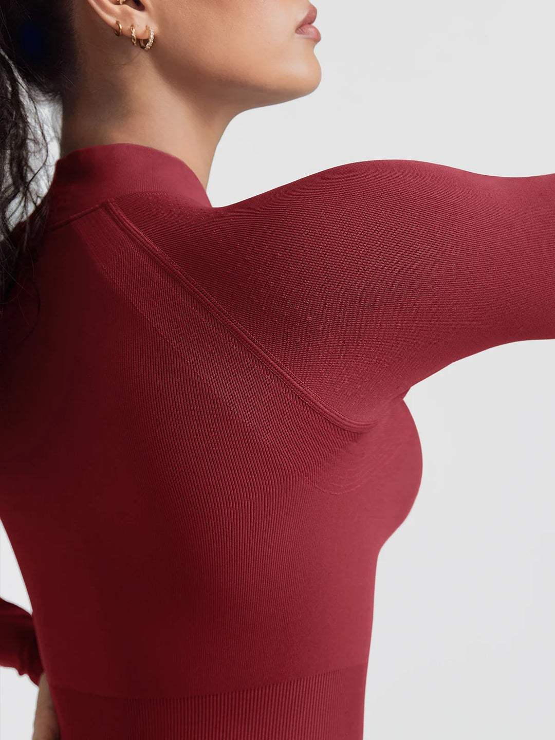 A model wearing a BRXL® BrxlGrit™ Long Sleeve Sculpting Contrast Workout Zip Up Jumpsuit