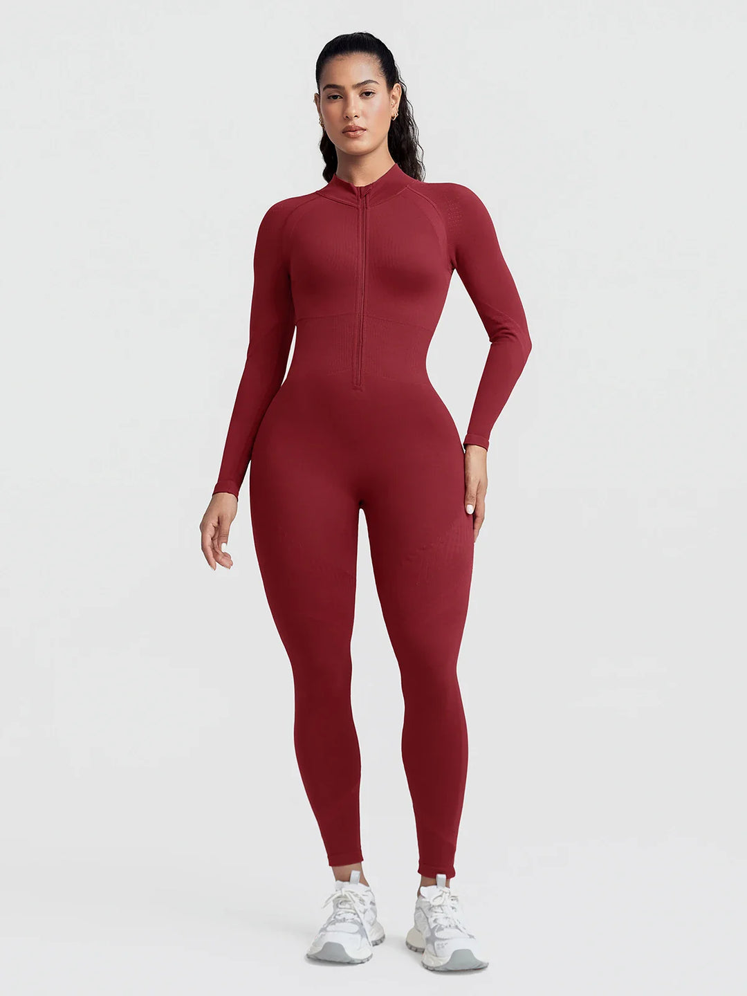 A model wearing a BRXL® BrxlGrit™ Long Sleeve Sculpting Contrast Workout Zip Up Jumpsuit Burgundy / XS