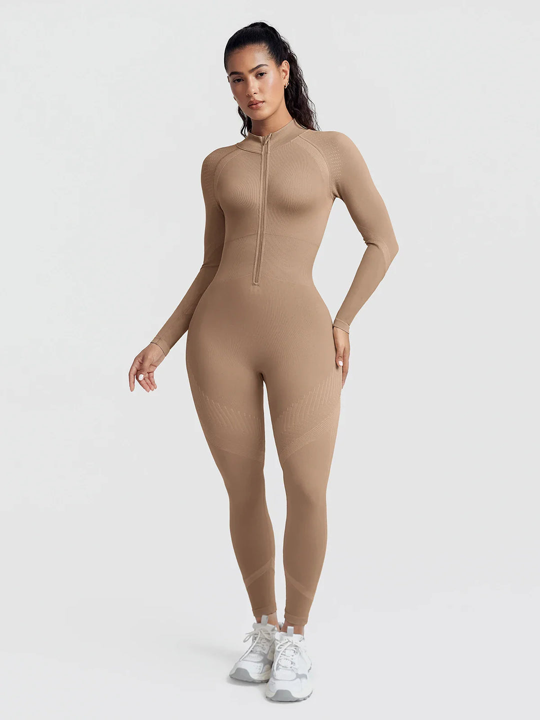 A model wearing a BRXL® BrxlGrit™ Long Sleeve Sculpting Contrast Workout Zip Up Jumpsuit Walnut Brown / XS