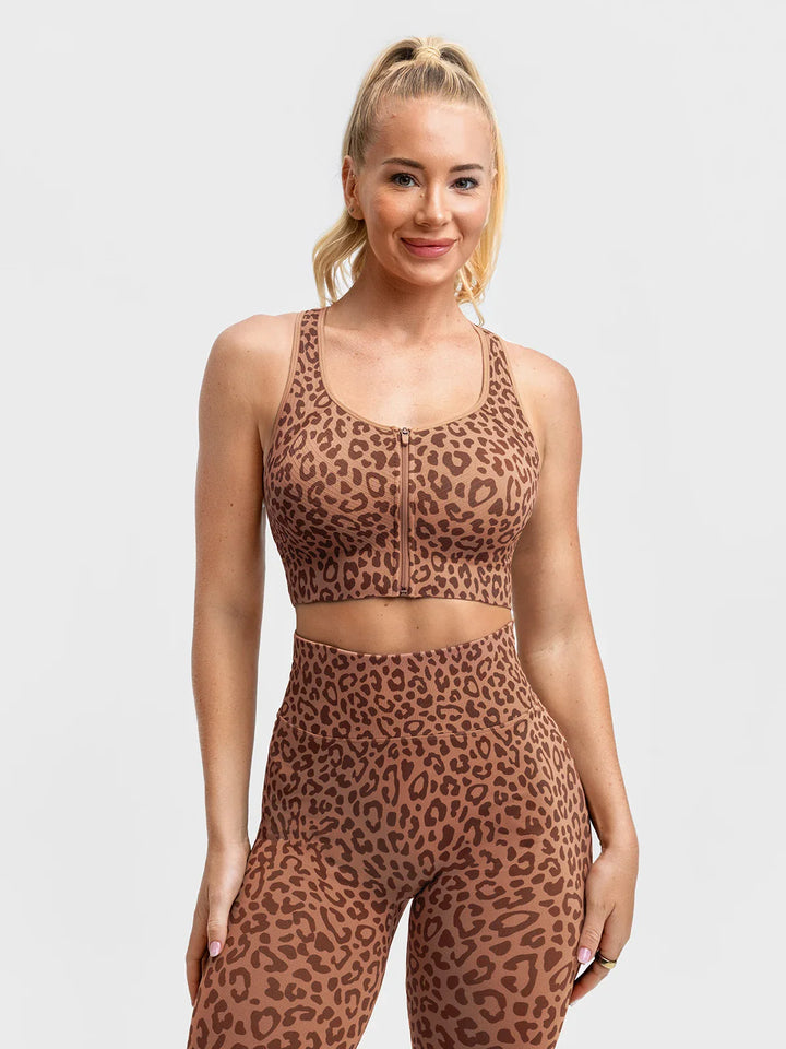 A model wearing a BRXL® BrxlGrit™ Seamless Front Zip Racerback Medium Impact Sports Bra Leopard / XS