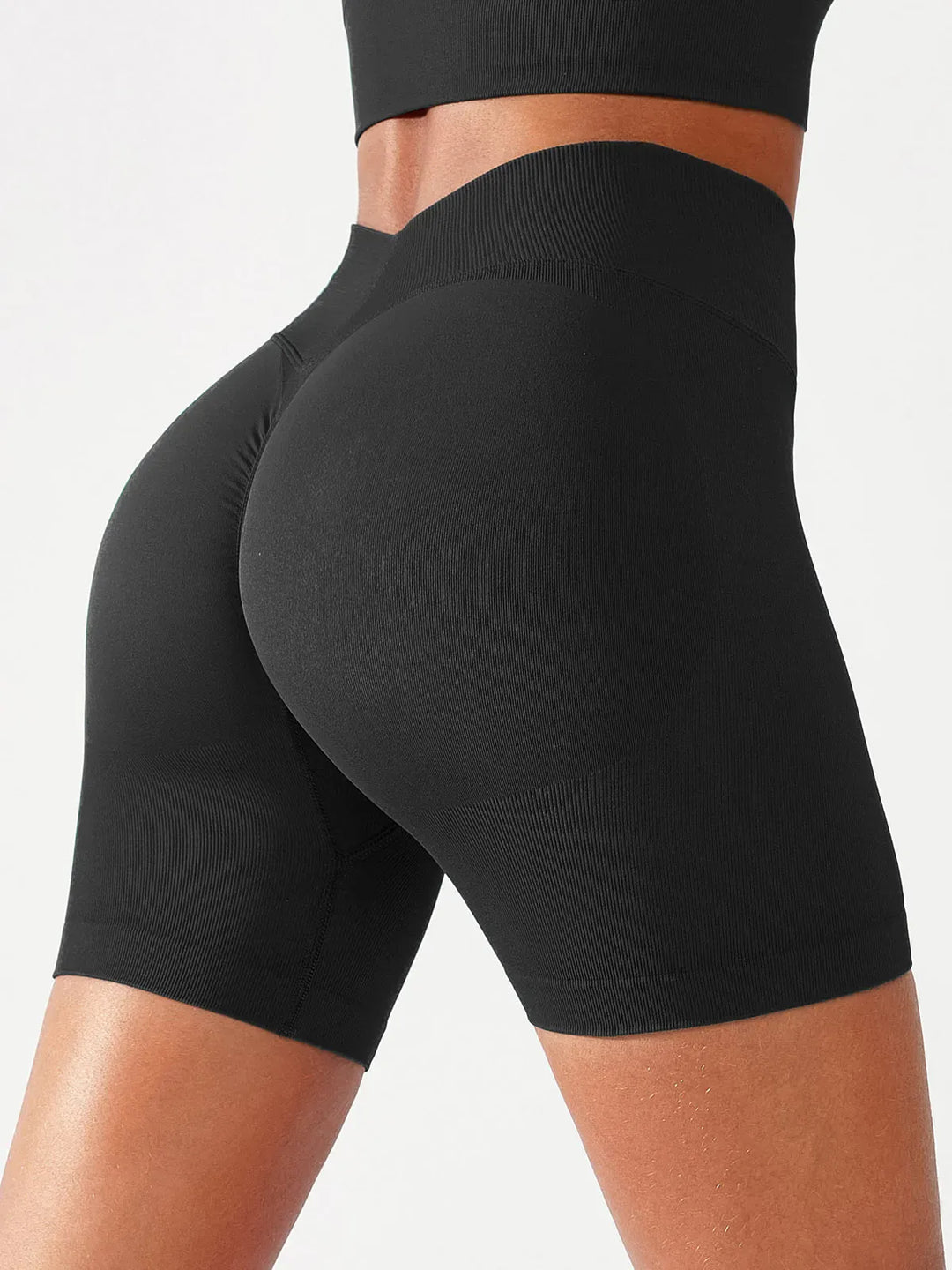 A model wearing a BRXL® BrxlGrit™ Seamless Scrunch Butt Workout Shorts in