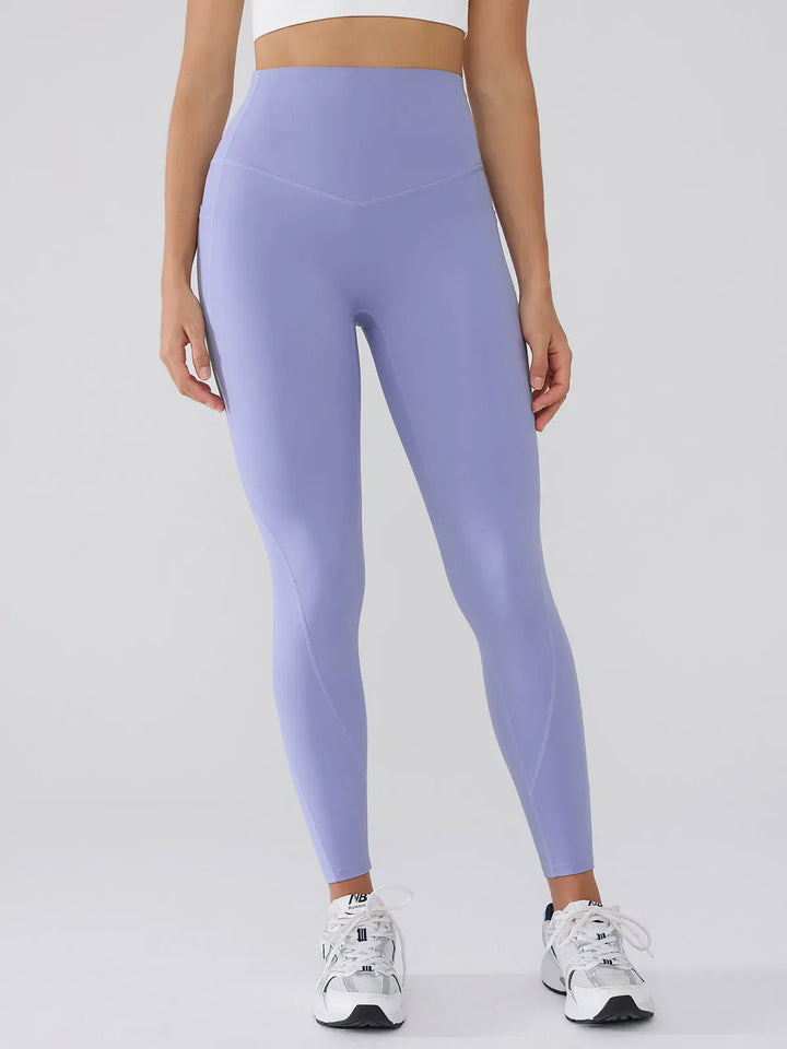 A model wearing a BRXL® BrxlGrit™ Tummy Control High Waisted Leggings in