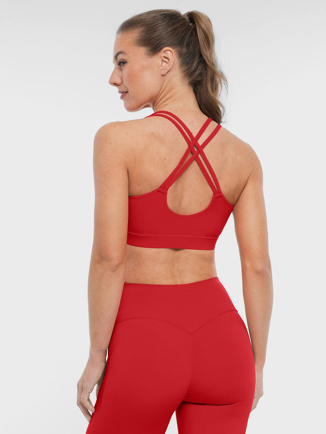 A model wearing a BRXL® BrxlZero™ Cross Back Strappy Sports Bra in