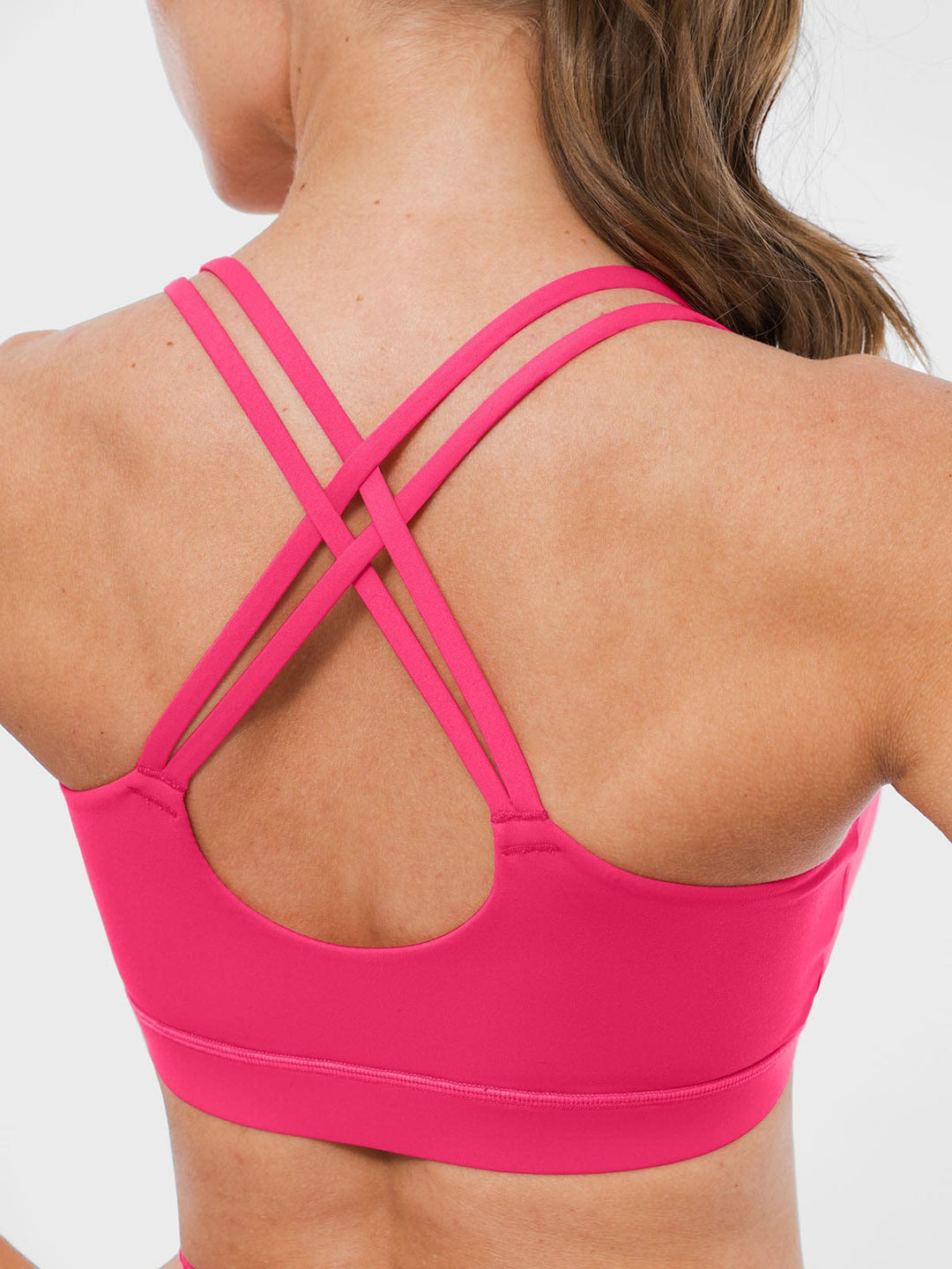 A model wearing a BRXL® BrxlZero™ Cross Back Strappy Sports Bra in