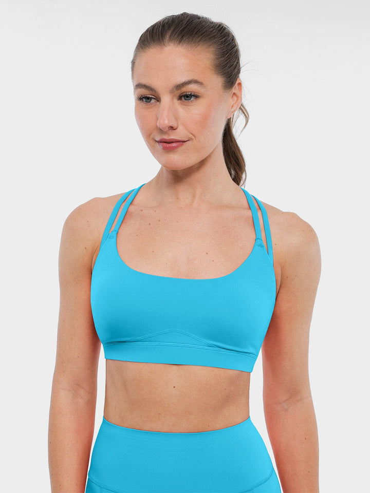 A model wearing a BRXL® BrxlZero™ Cross Back Strappy Sports Bra in