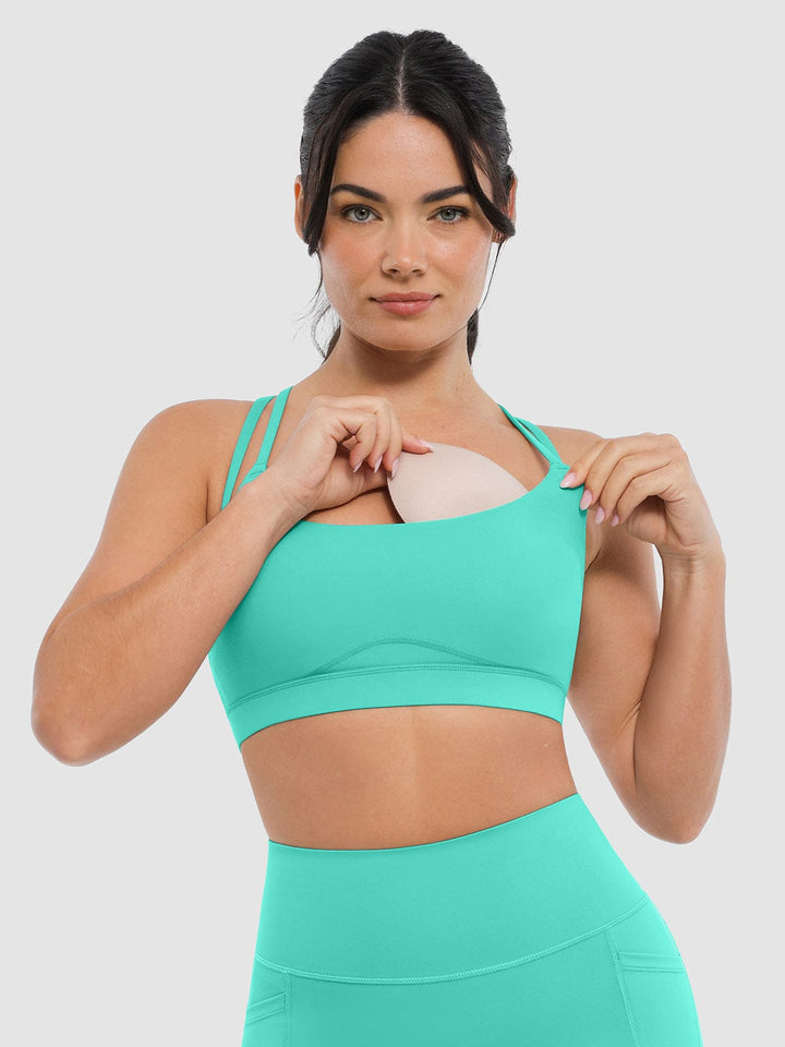 A model wearing a BRXL® BrxlZero™ Cross Back Strappy Sports Bra in