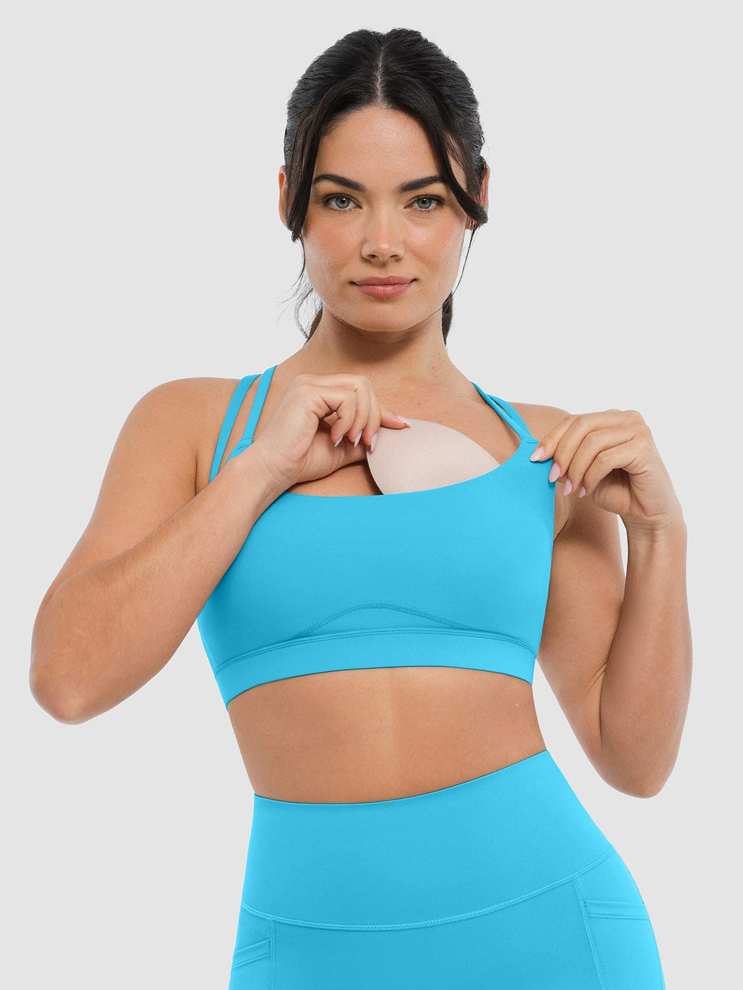 A model wearing a BRXL® BrxlZero™ Cross Back Strappy Sports Bra in