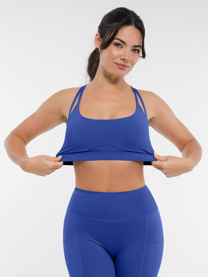 A model wearing a BRXL® BrxlZero™ Cross Back Strappy Sports Bra in
