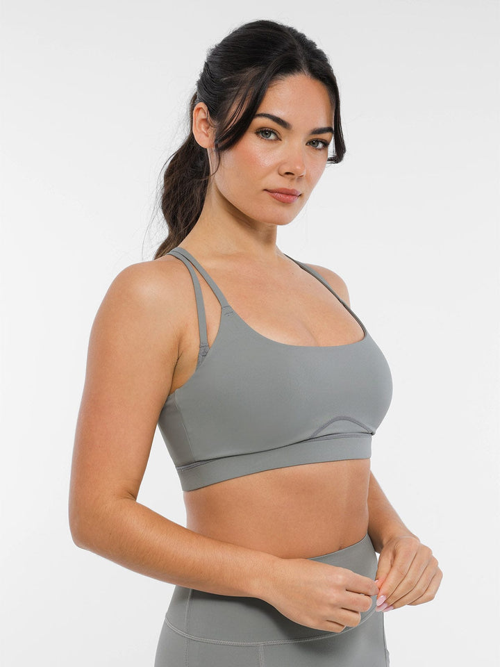 A model wearing a BRXL® BrxlZero™ Cross Back Strappy Sports Bra in