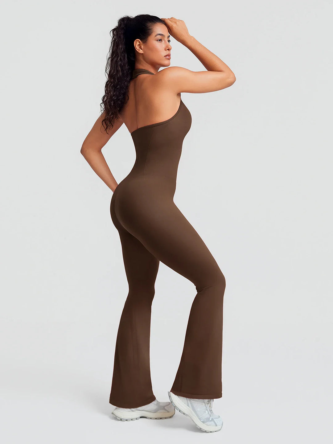 A model wearing a BRXL® BrxlZero® Halter Neck Sculpt Seamless Flare Jumpsuit