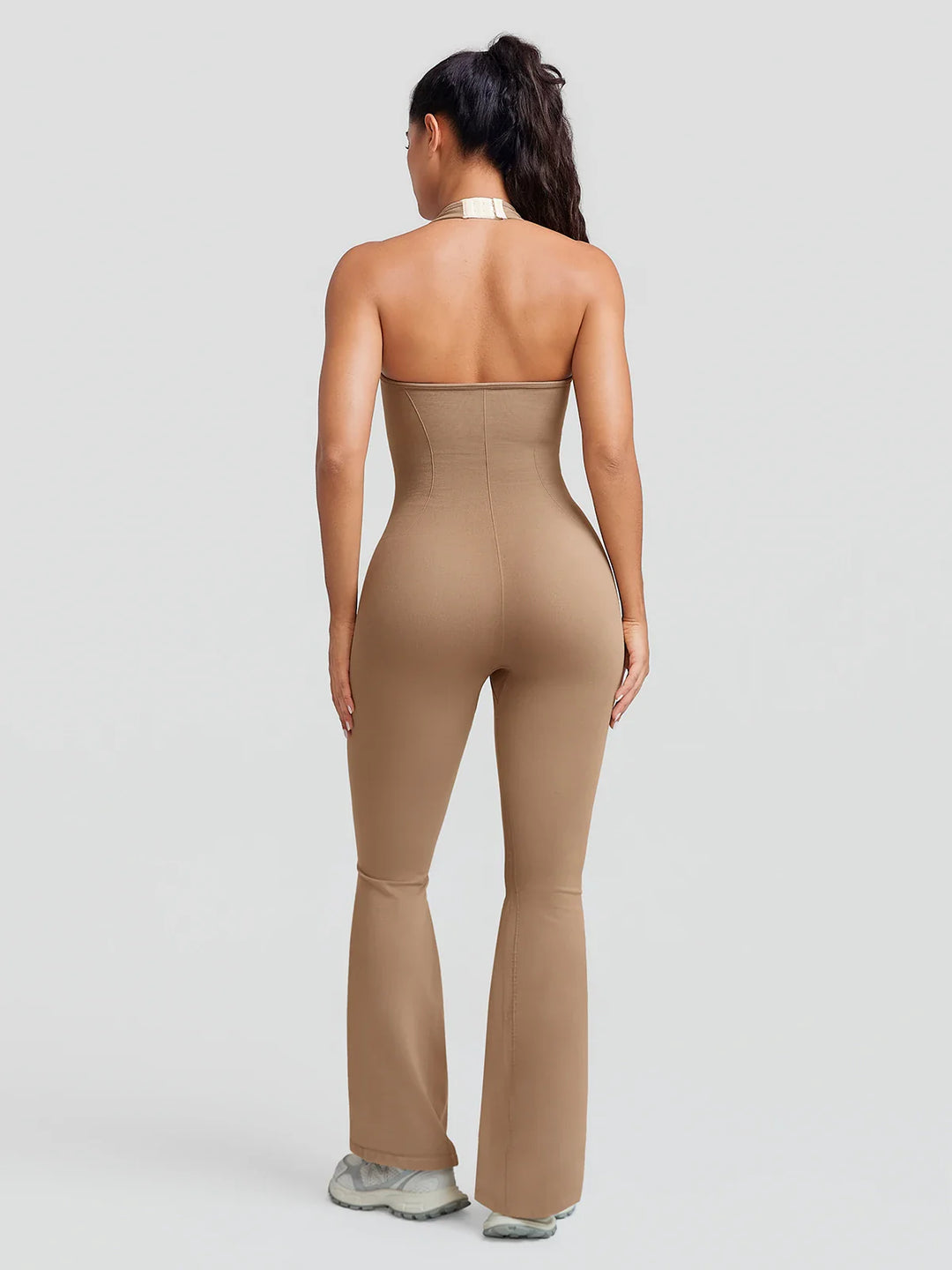 A model wearing a BRXL® BrxlZero® Halter Neck Sculpt Seamless Flare Jumpsuit
