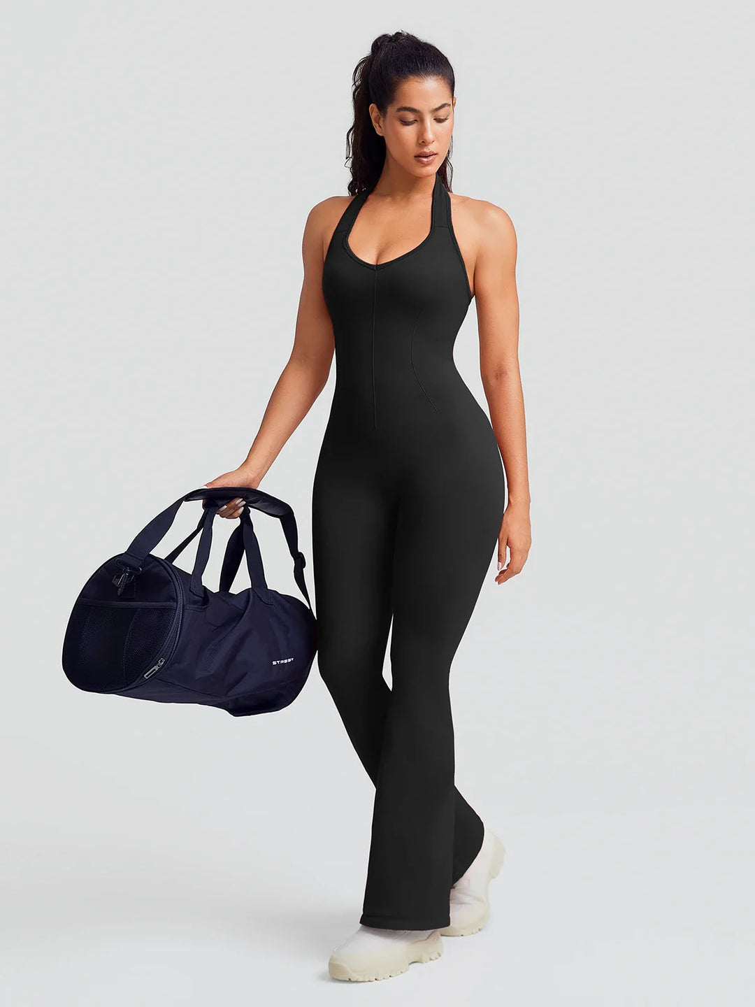 A model wearing a BRXL® BrxlZero® Halter Neck Sculpt Seamless Flare Jumpsuit