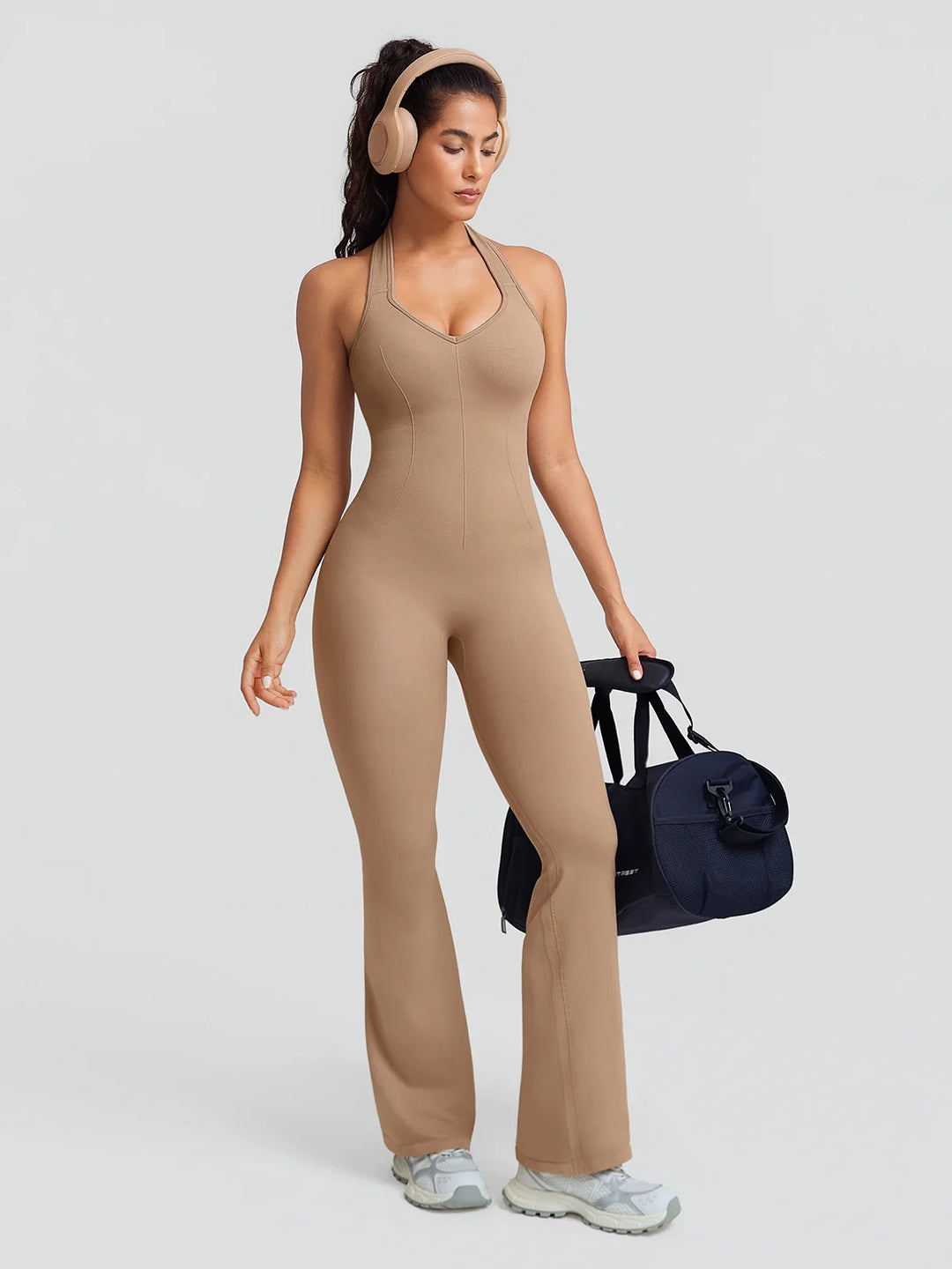 A model wearing a BRXL® BrxlZero® Halter Neck Sculpt Seamless Flare Jumpsuit