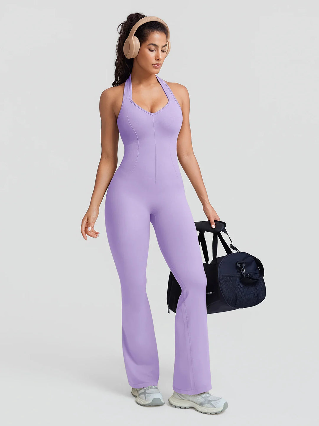 A model wearing a BRXL® BrxlZero® Halter Neck Sculpt Seamless Flare Jumpsuit