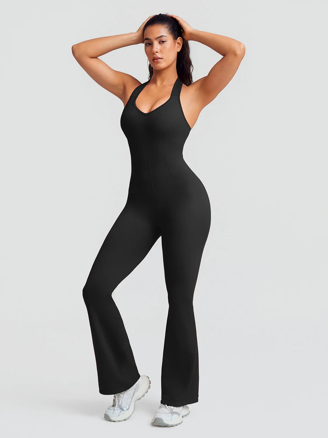A model wearing a BRXL® BrxlZero® Halter Neck Sculpt Seamless Flare Jumpsuit Black / XS
