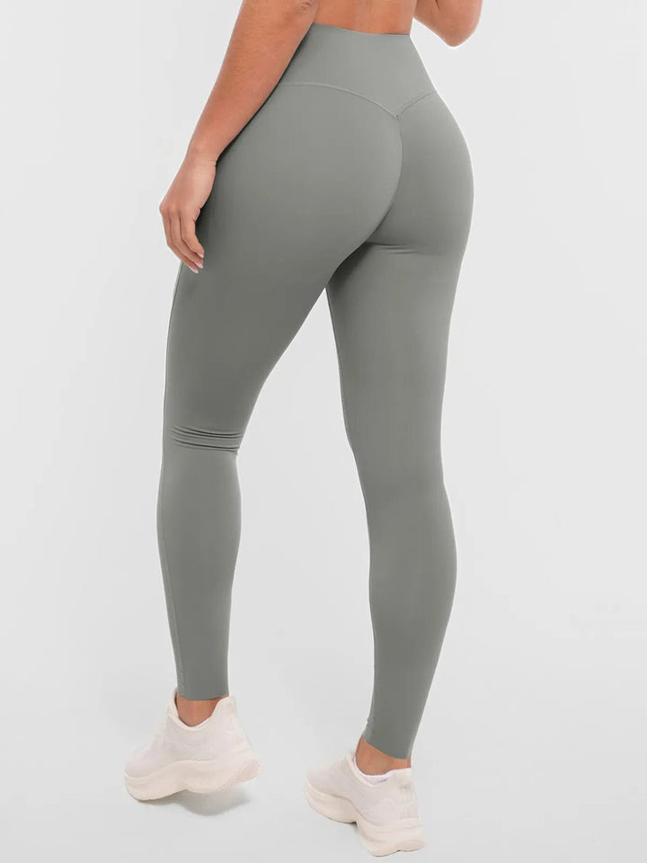 A model wearing a BRXL® BrxlZero™ High Rise Buttery Soft Yoga Leggings in