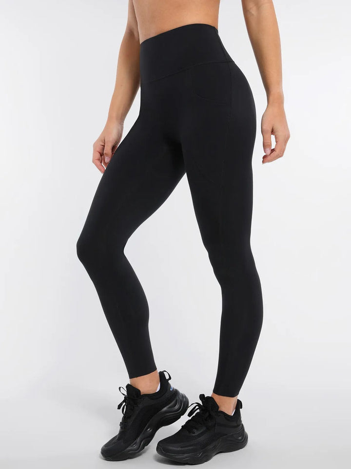 A model wearing a BRXL® BrxlZero™ High Rise Buttery Soft Yoga Leggings in