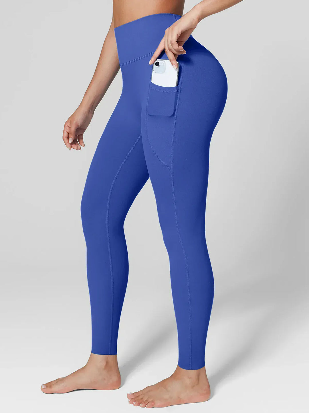 A model wearing a BRXL® BrxlZero™ High Rise Side Pockets Buttery Soft Yoga Leggings