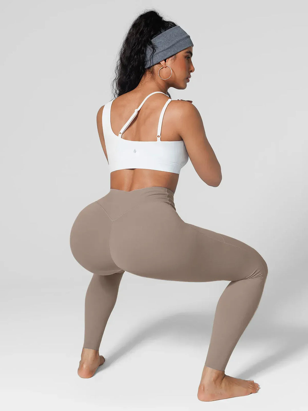 A model wearing a BRXL® BrxlZero™ High Rise Side Pockets Buttery Soft Yoga Leggings