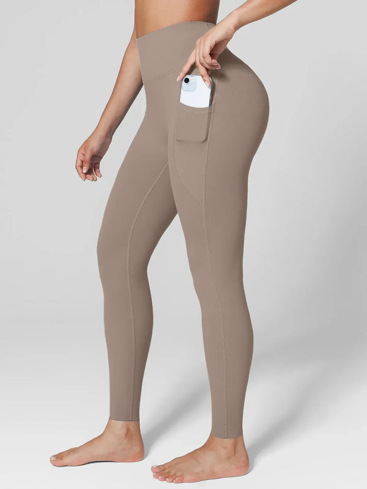 A model wearing a BRXL® BrxlZero™ High Rise Side Pockets Buttery Soft Yoga Leggings
