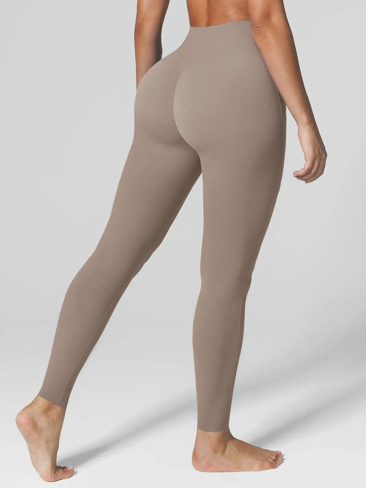A model wearing a BRXL® BrxlZero™ High Rise Side Pockets Buttery Soft Yoga Leggings