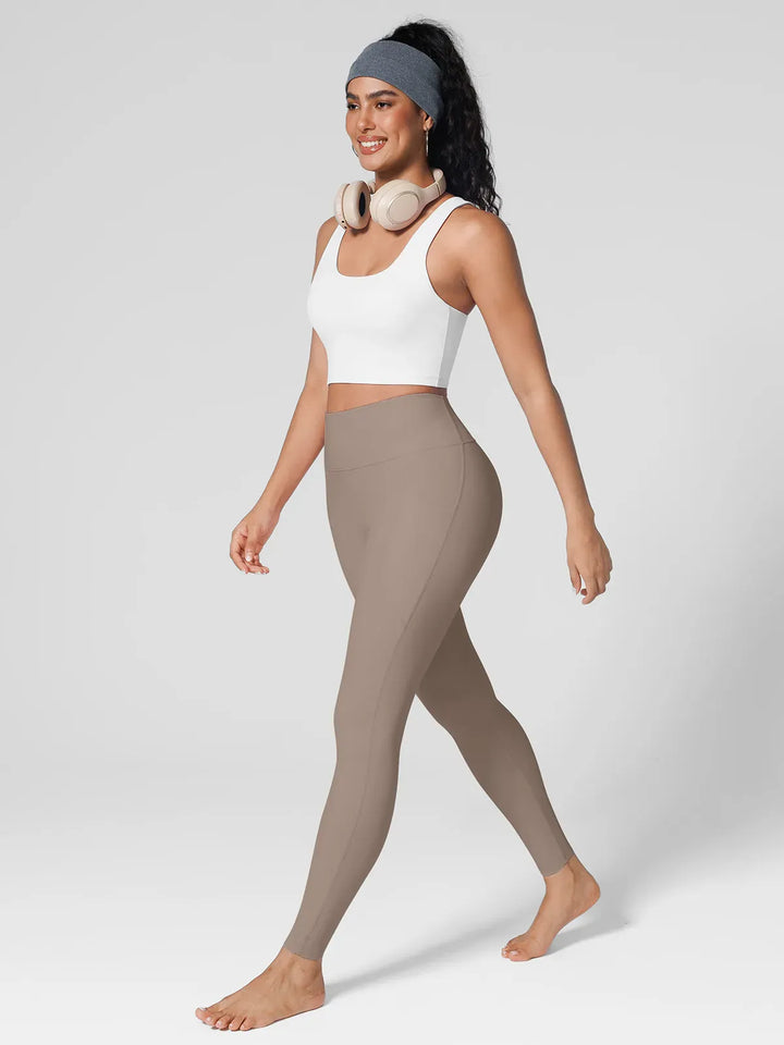 A model wearing a BRXL® BrxlZero™ High Rise Side Pockets Buttery Soft Yoga Leggings in
