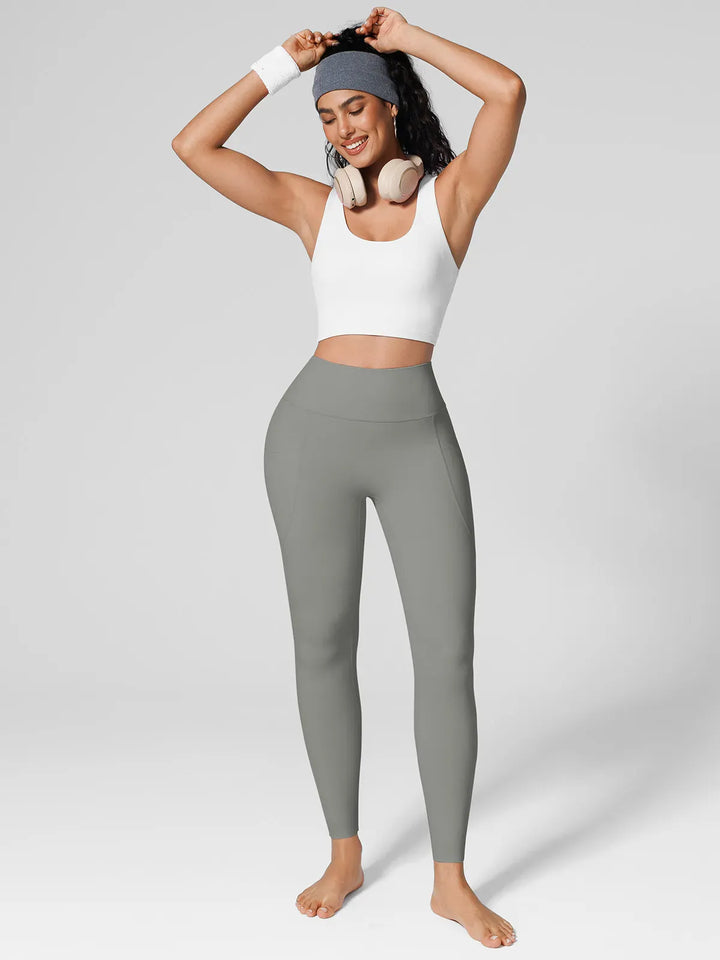 A model wearing a BRXL® BrxlZero™ High Rise Side Pockets Buttery Soft Yoga Leggings