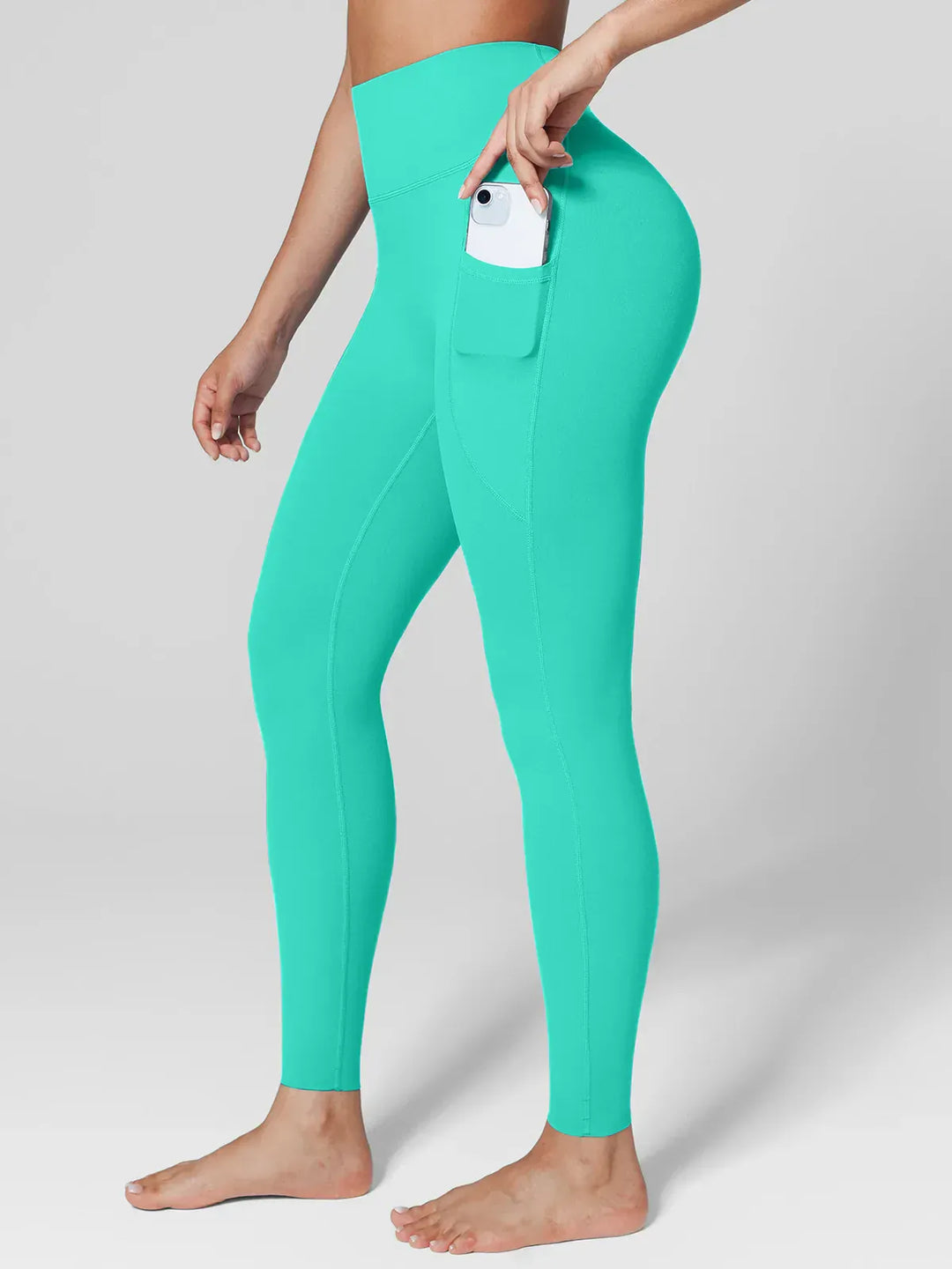 A model wearing a BRXL® BrxlZero™ High Rise Side Pockets Buttery Soft Yoga Leggings in