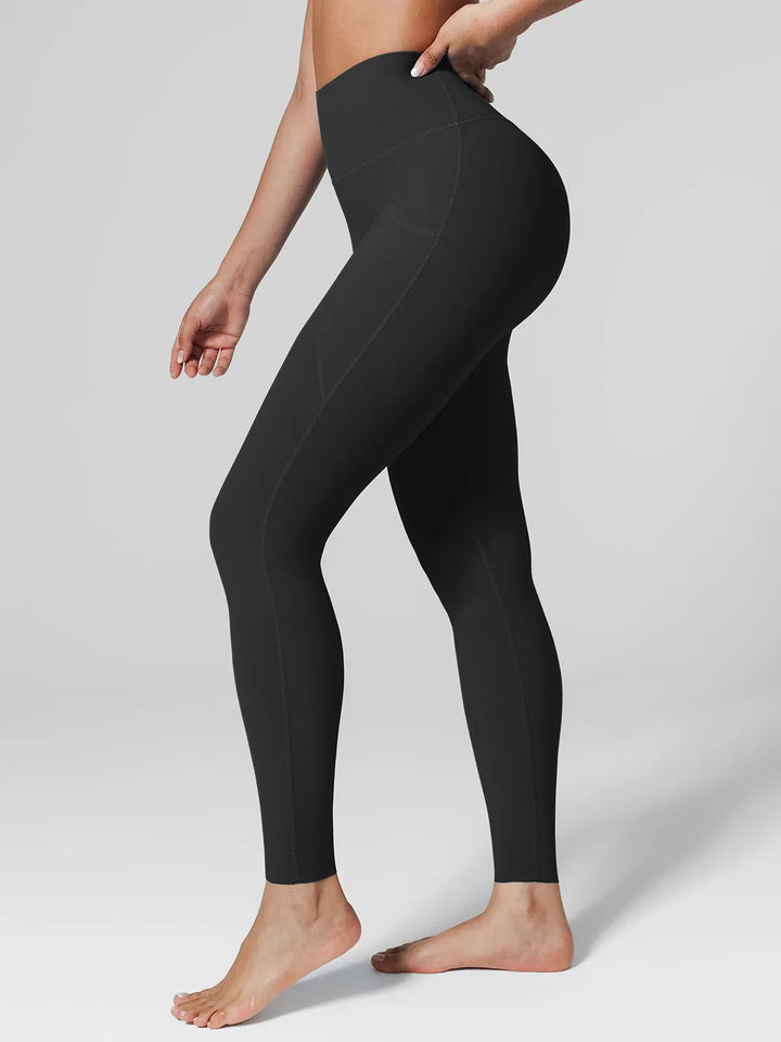 A model wearing a BRXL® BrxlZero™ High Rise Side Pockets Buttery Soft Yoga Leggings in Black / XS