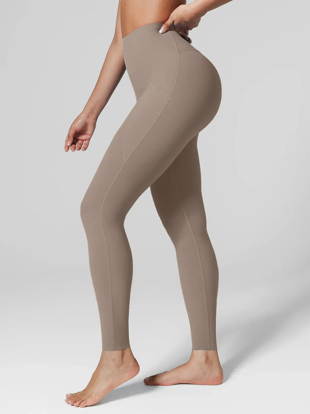 A model wearing a BRXL® BrxlZero™ High Rise Side Pockets Buttery Soft Yoga Leggings Charcoal / XS