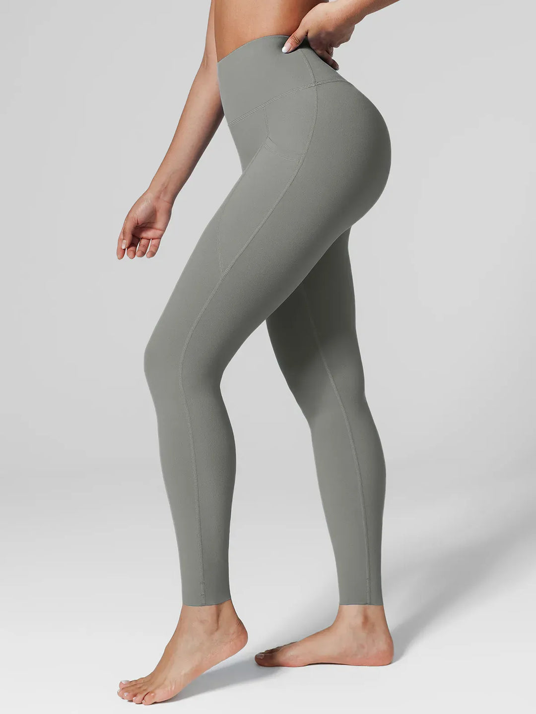 A model wearing a BRXL® BrxlZero™ High Rise Side Pockets Buttery Soft Yoga Leggings in Gray / XS