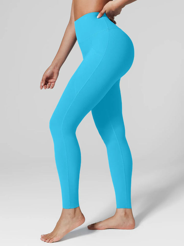 A model wearing a BRXL® BrxlZero™ High Rise Side Pockets Buttery Soft Yoga Leggings Light Blue / XS