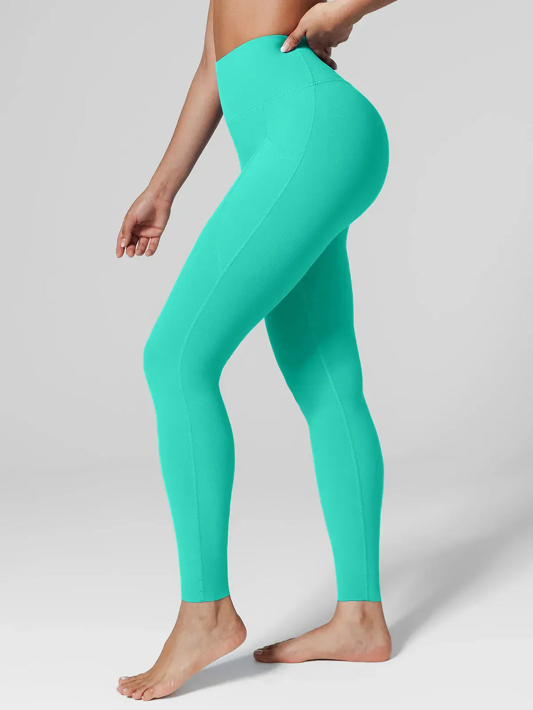 A model wearing a BRXL® BrxlZero™ High Rise Side Pockets Buttery Soft Yoga Leggings Mint Green / XS