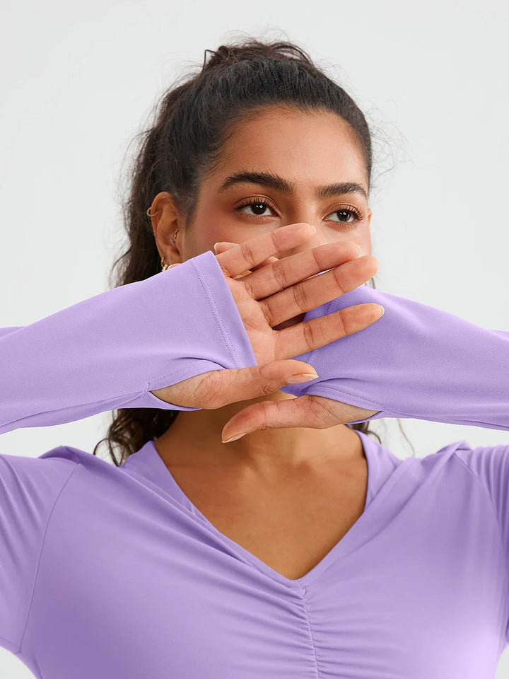A model wearing a BRXL® BrxlZero® Off Shoulder Long Sleeve Crop Top with Built-In Bra
