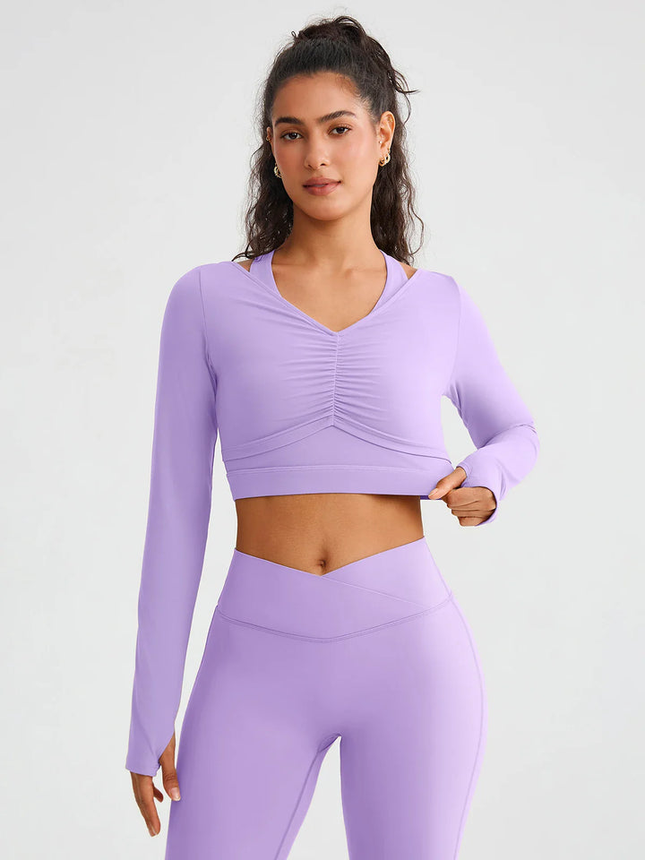 A model wearing a BRXL® BrxlZero® Off Shoulder Long Sleeve Crop Top with Built-In Bra