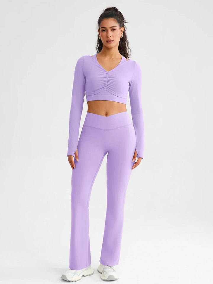 A model wearing a BRXL® BrxlZero® Off Shoulder Long Sleeve Crop Top with Built-In Bra