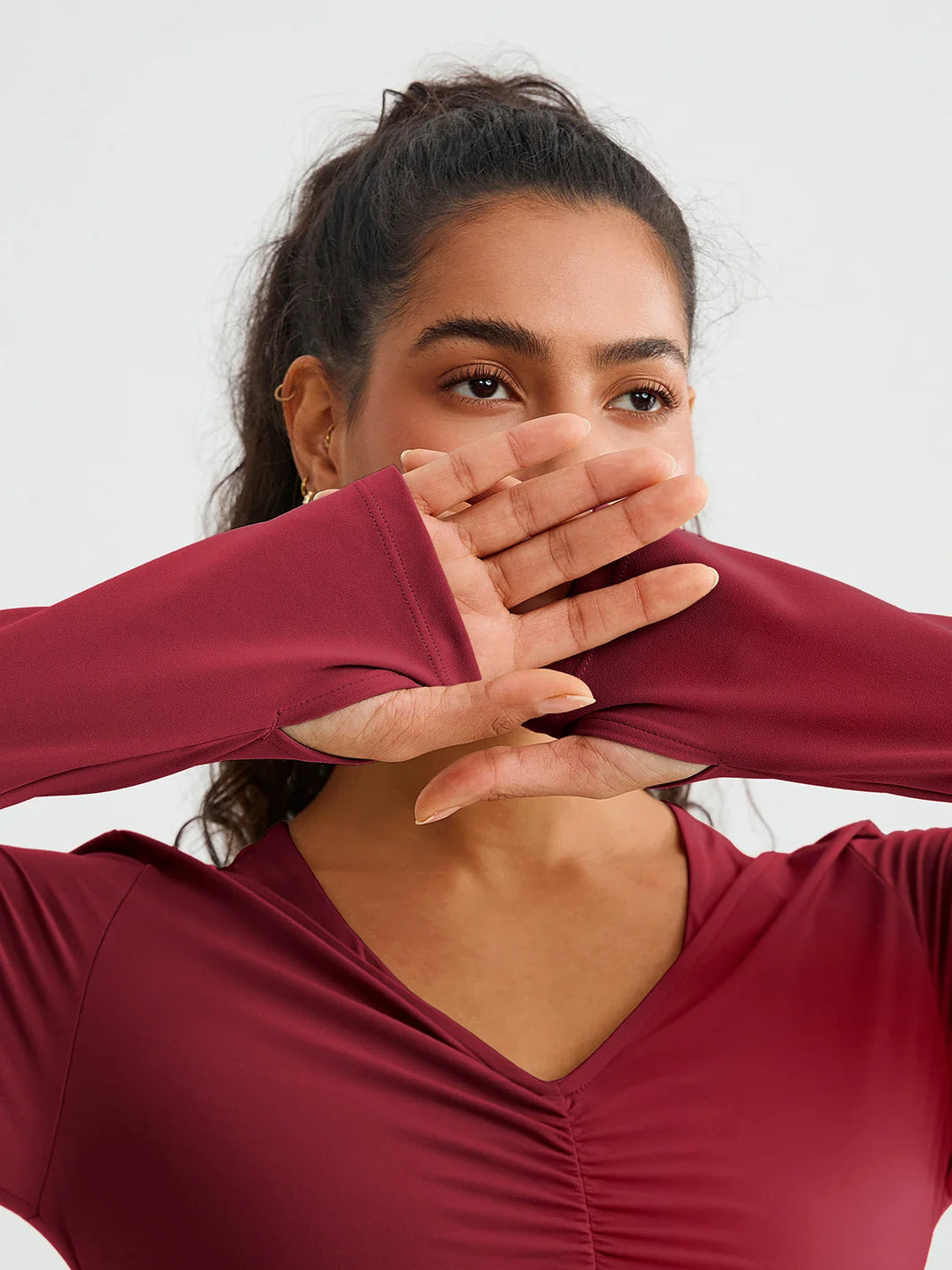 A model wearing a BRXL® BrxlZero® Off Shoulder Long Sleeve Crop Top with Built-In Bra