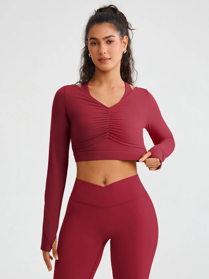 A model wearing a BRXL® BrxlZero® Off Shoulder Long Sleeve Crop Top with Built-In Bra
