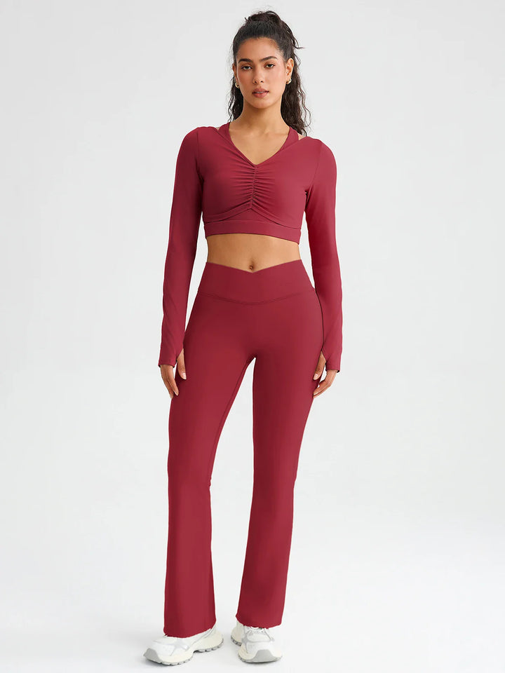 A model wearing a BRXL® BrxlZero® Off Shoulder Long Sleeve Crop Top with Built-In Bra