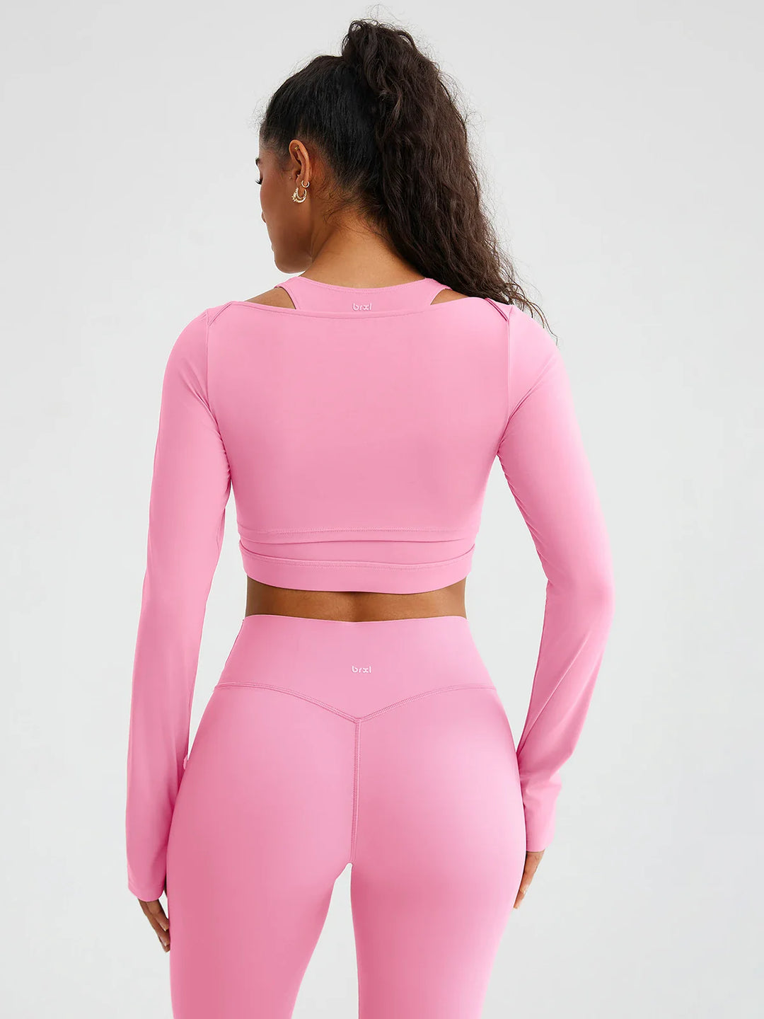 A model wearing a BRXL® BrxlZero® Off Shoulder Long Sleeve Crop Top with Built-In Bra