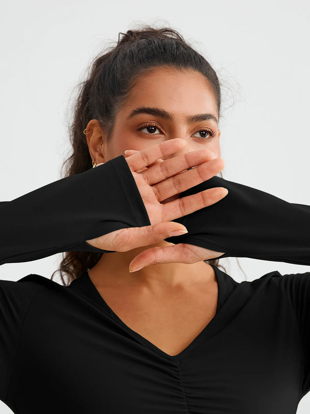 A model wearing a BRXL® BrxlZero® Off Shoulder Long Sleeve Crop Top with Built-In Bra