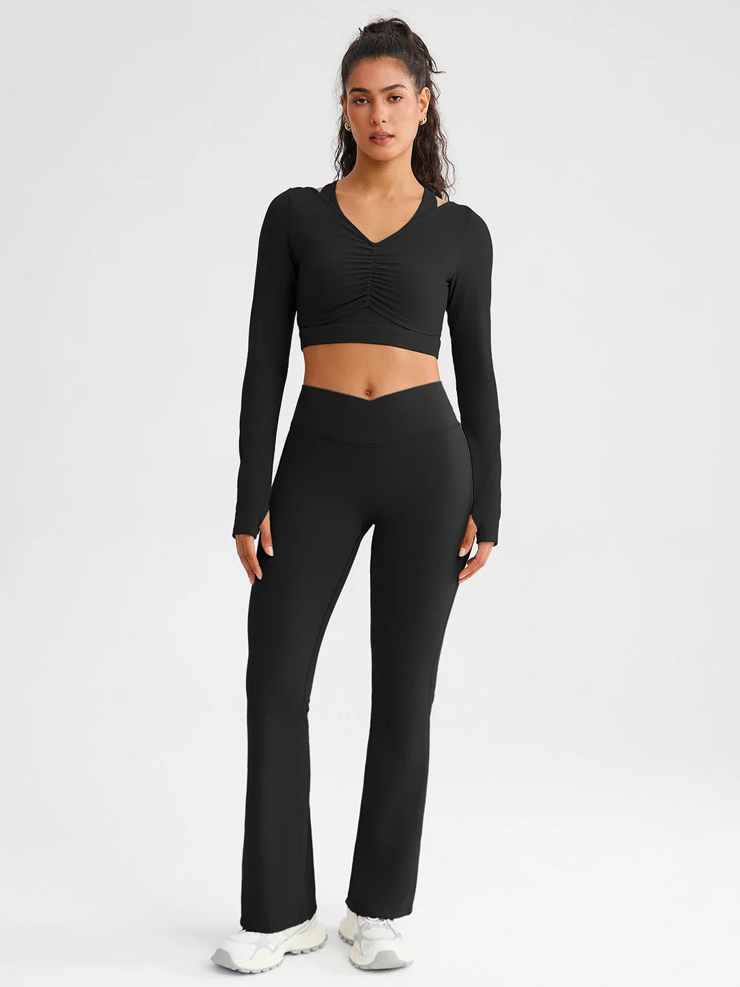A model wearing a BRXL® BrxlZero® Off Shoulder Long Sleeve Crop Top with Built-In Bra