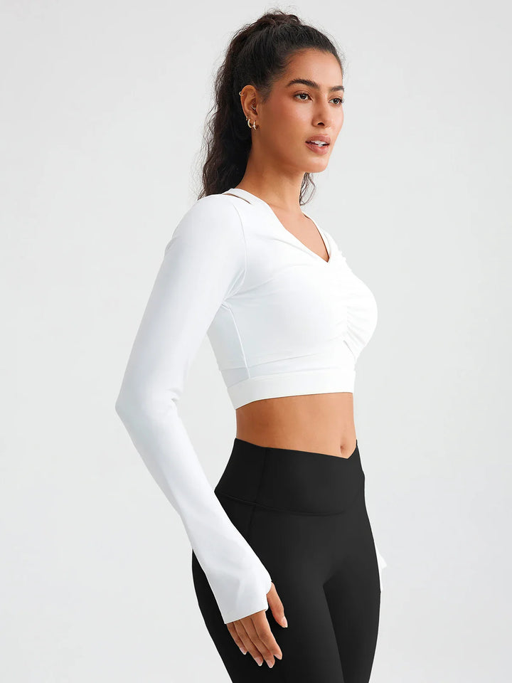 A model wearing a BRXL® BrxlZero® Off Shoulder Long Sleeve Crop Top with Built-In Bra