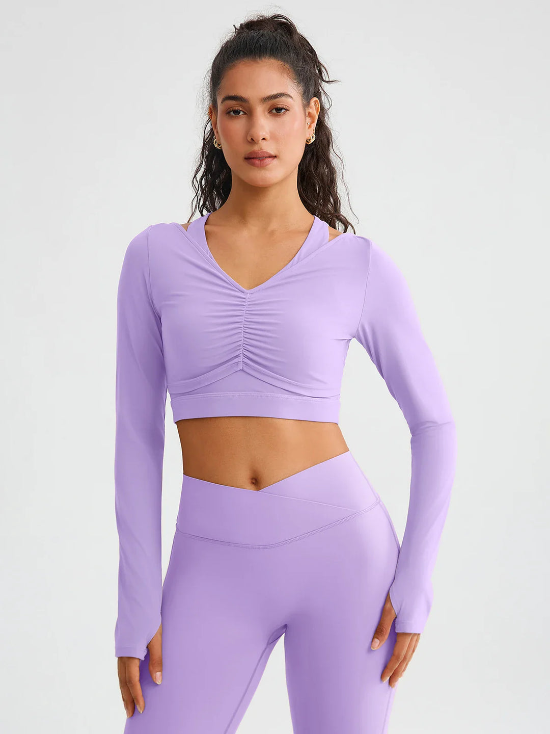 A model wearing a BRXL® BrxlZero® Off Shoulder Long Sleeve Crop Top with Built-In Bra Dusty Purple / XS