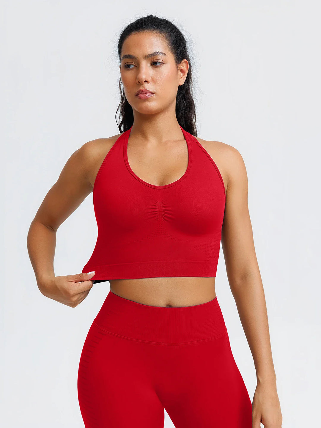 A model wearing a BRXL® BrxlZero® Seamless Ribbed Scoop-Neck Halter Sports Tank Top