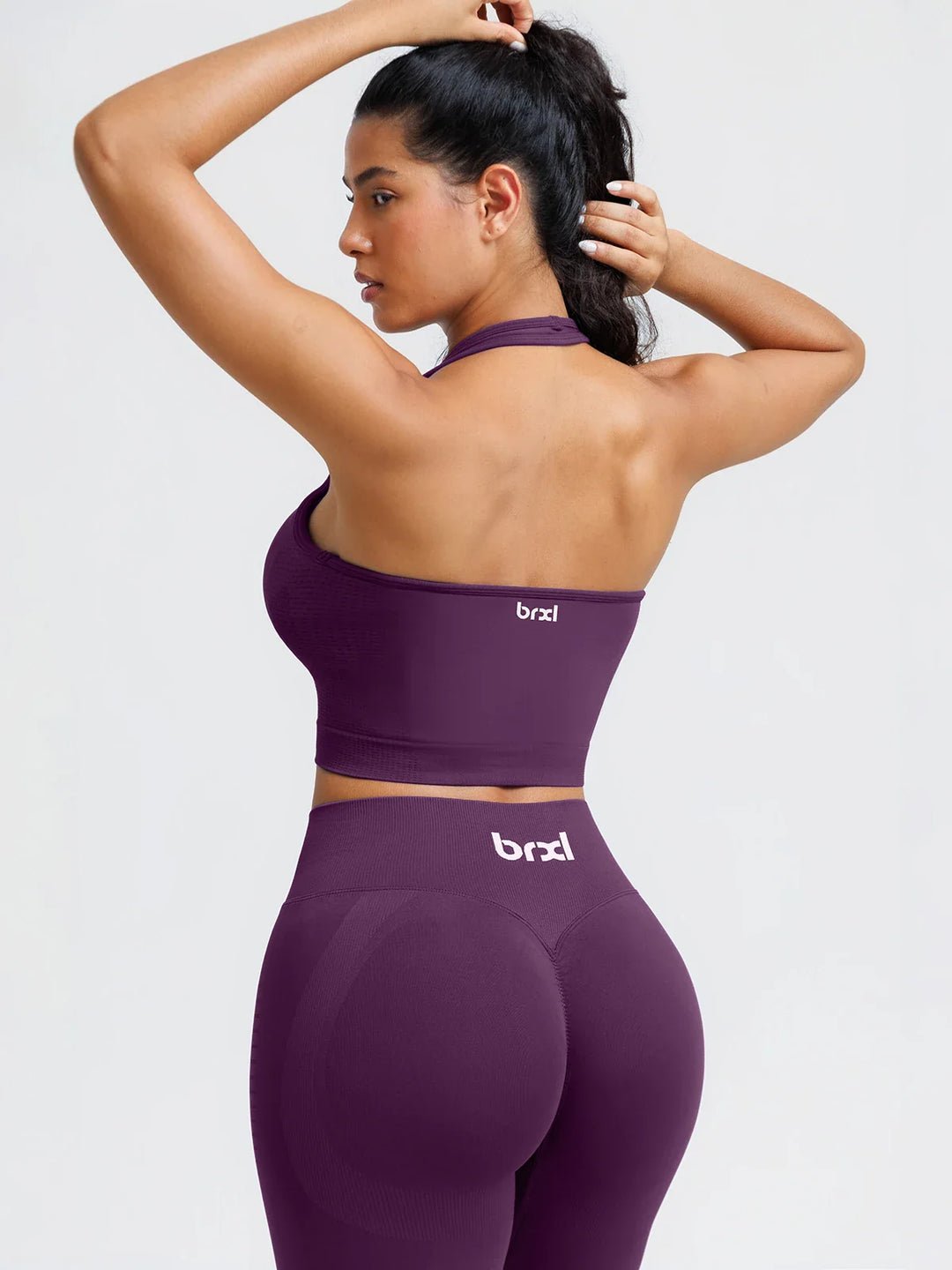 A model wearing a BRXL® BrxlZero® Seamless Ribbed Scoop-Neck Halter Sports Tank Top