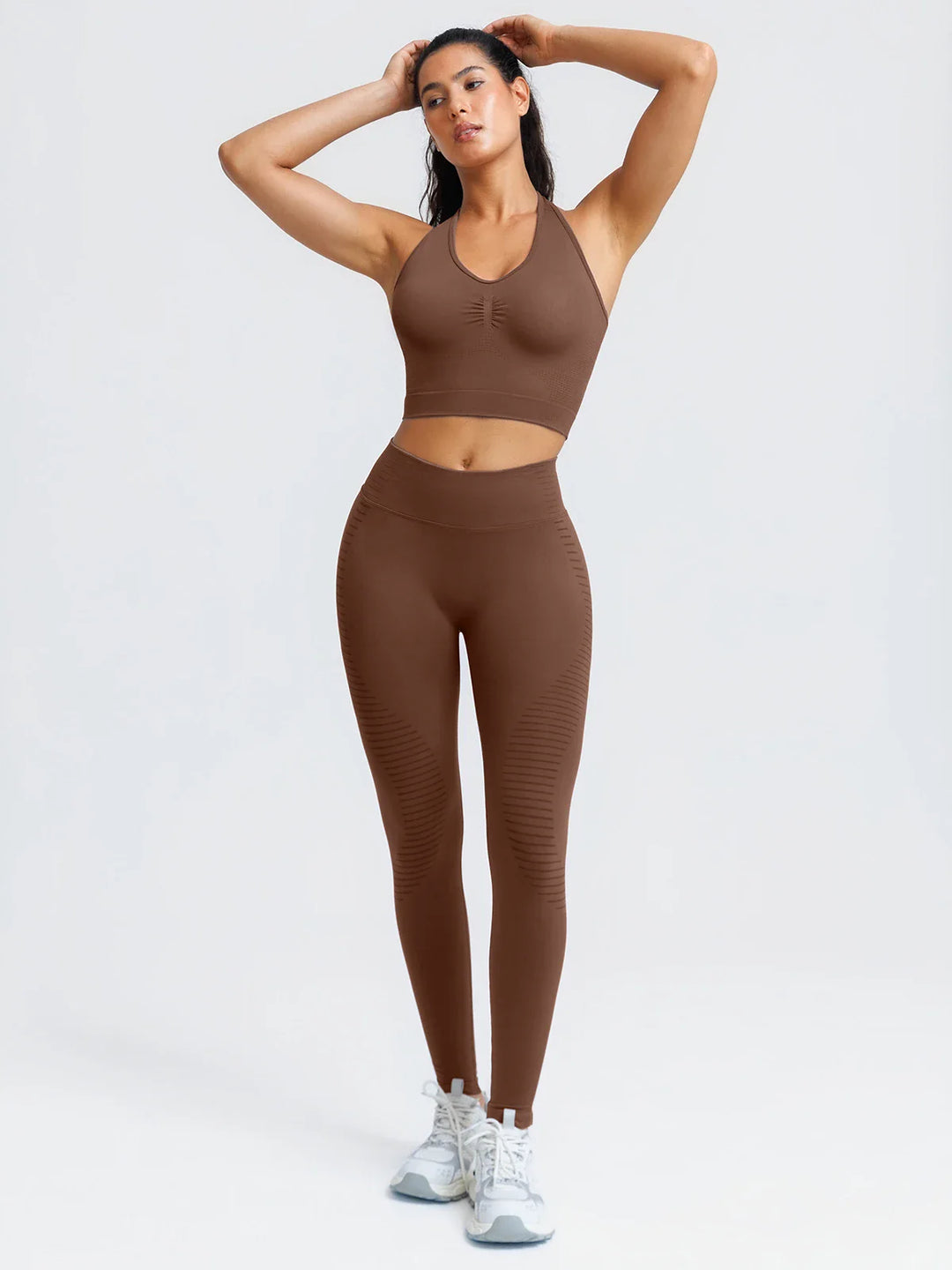 A model wearing a BRXL® BrxlZero® Seamless Ribbed Scoop-Neck Halter Sports Tank Top